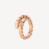 Rose gold ring with geometric design on a white background