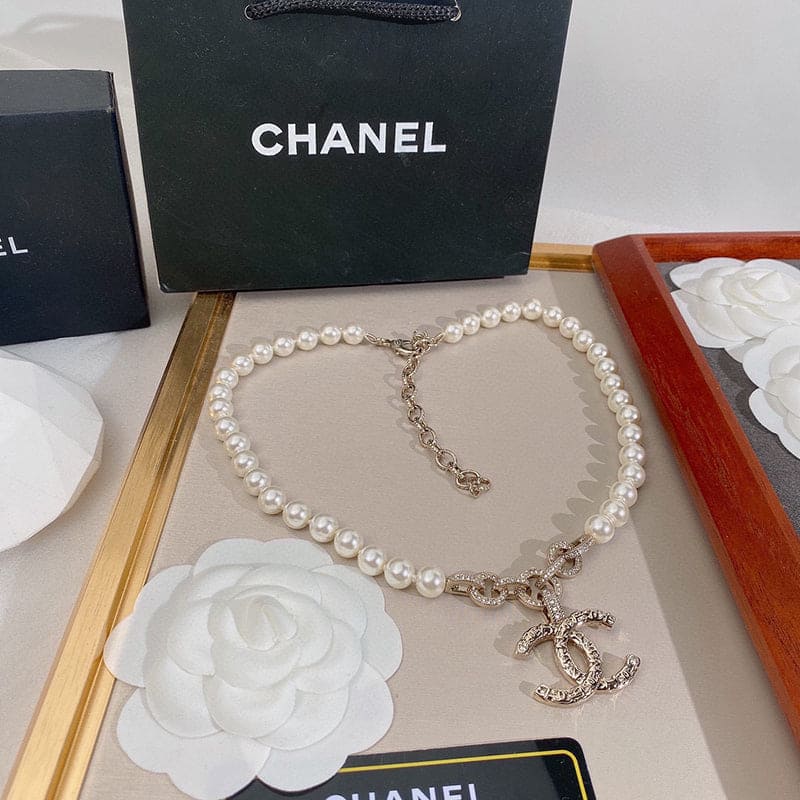 Pearl necklace with Chanel logo on a branded box