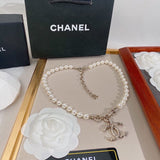 Pearl necklace with Chanel logo on a branded box