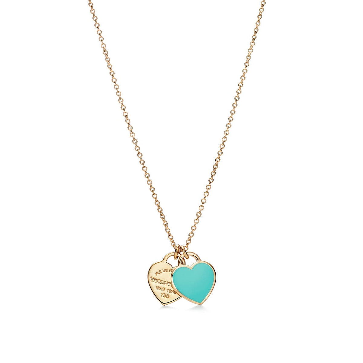 A gold chain necklace with two heart-shaped tags, one in polished gold with engraved text and the other in a vibrant turquoise enamel finish, shown on a plain white background.