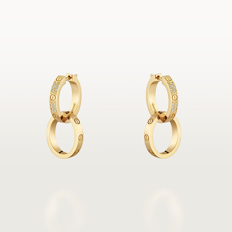 Gold hoop earrings with embedded stones on a light gray background