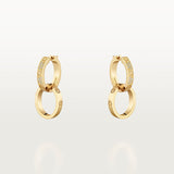 Gold hoop earrings with embedded stones on a light gray background