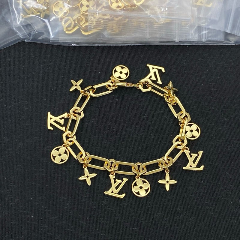 Gold bracelet with charms on a black background